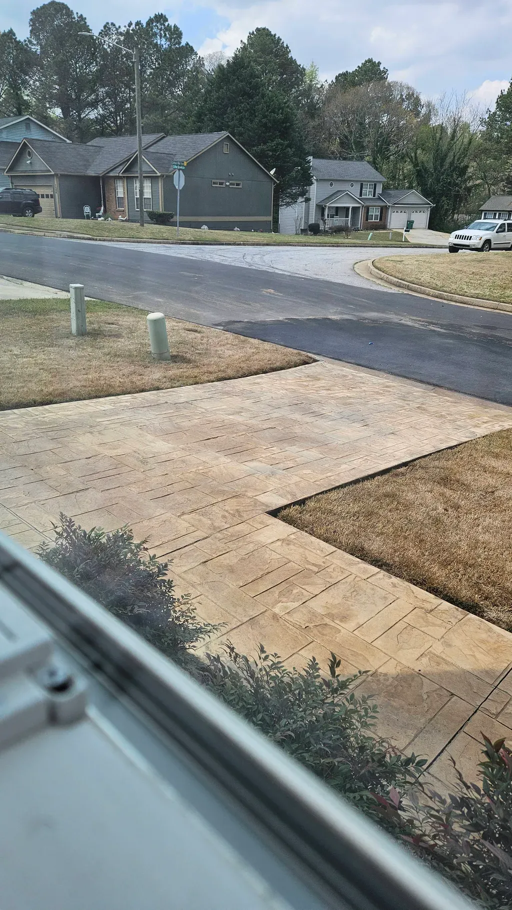 Tan stamped ashlar concrete driveway and walkway